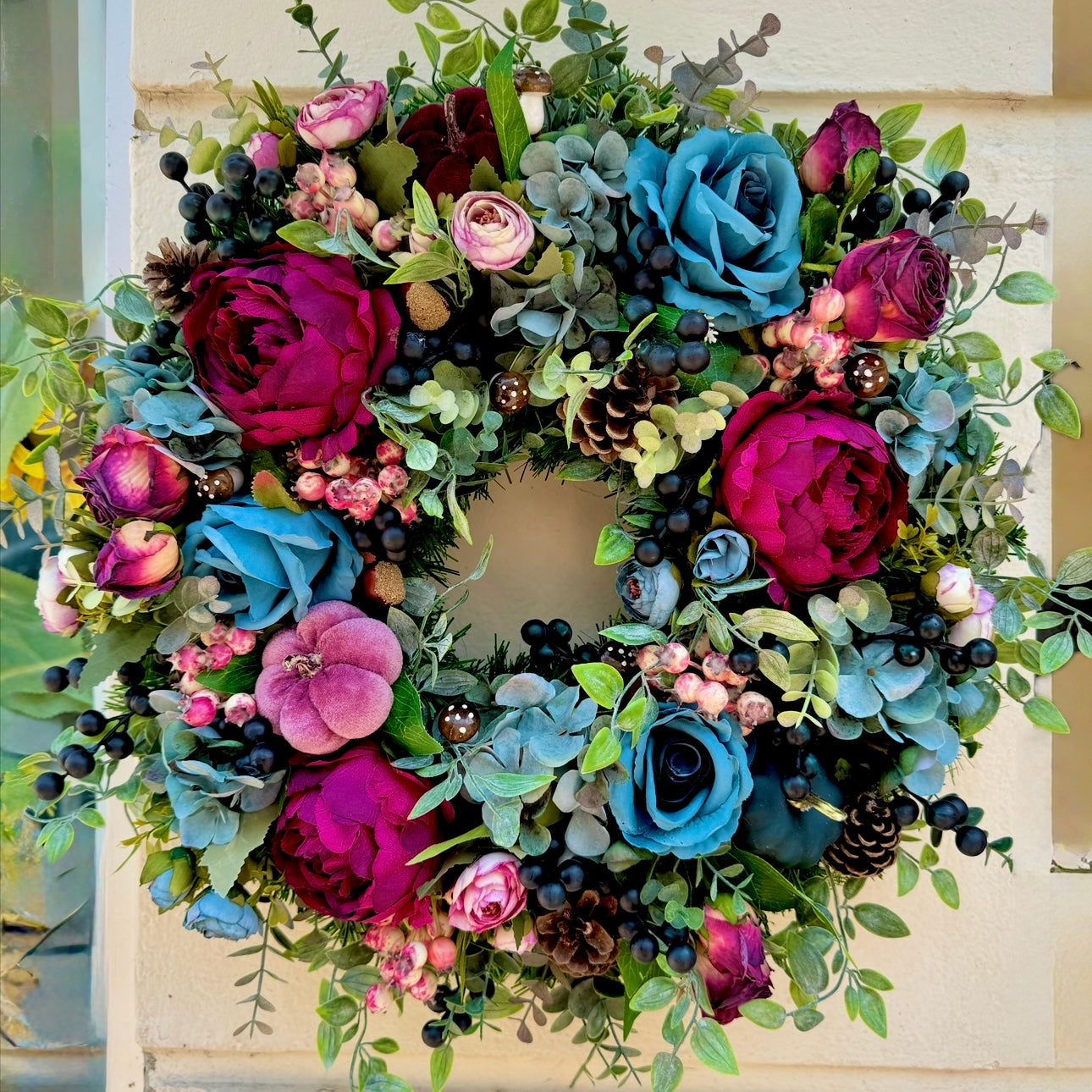 artificial autumn wreath, smoky blue hydrangeas, magenta peonies, black berries, pumpkins and foliage