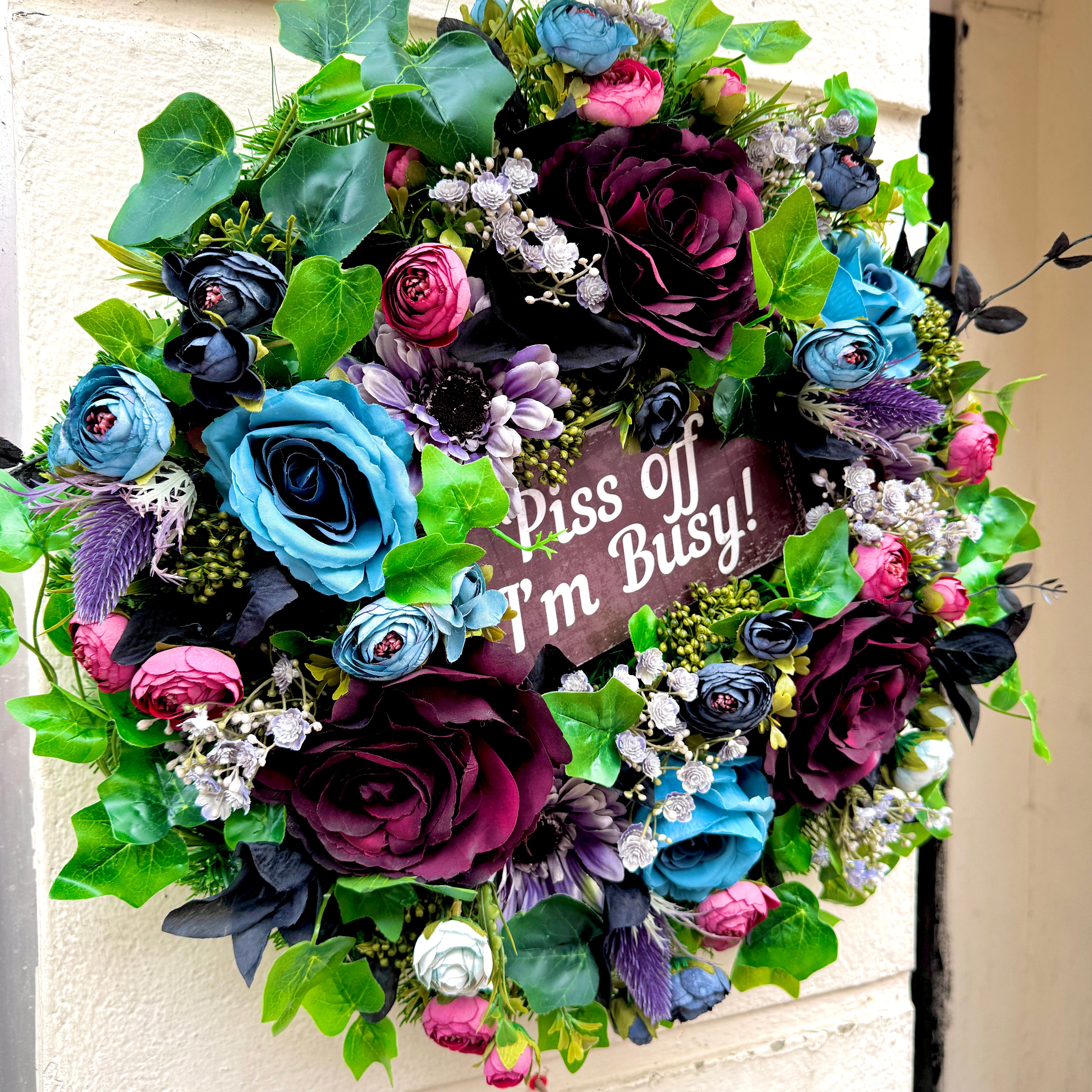 side view of jamesia blooms piss off i'm busy artificial wreath. Blue, burgundy, pink and black faux flowers