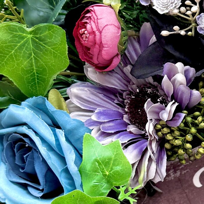 Close up of Cranky Karen wreath from The Karen Collection with "piss off I'm busy sign" deep blue and burgundy artificial florals, funny grumpy door decor