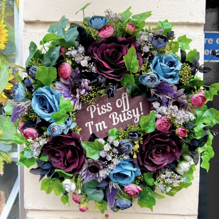 Cranky Karen wreath from the Jamesia Blooms Karen Collection with "piss off I'm busy sign" deep blue and burgundy artificial florals, funny grumpy door decor