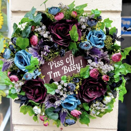 Cranky Karen wreath from the Jamesia Blooms Karen Collection with "piss off I'm busy sign" deep blue and burgundy artificial florals, funny grumpy door decor