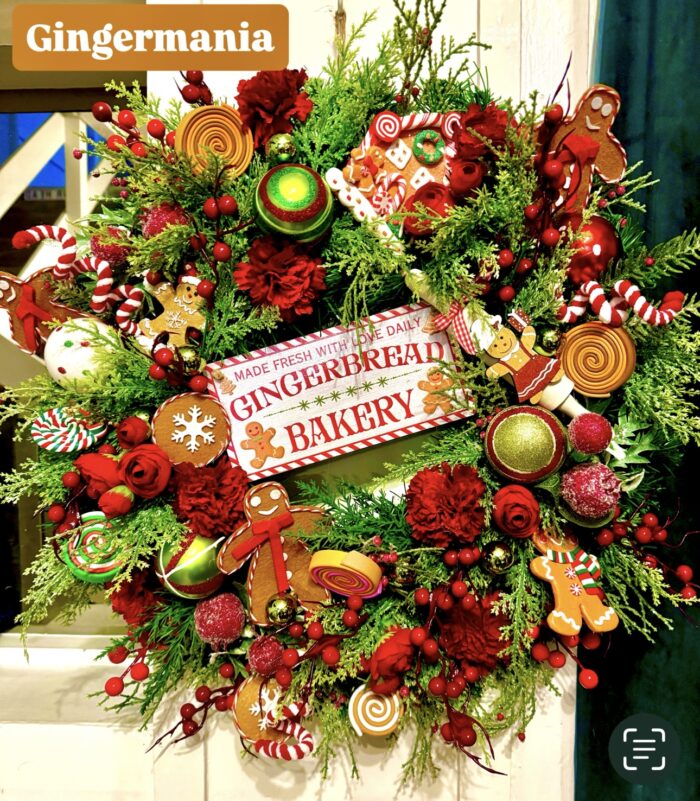 Gingermania Christmas wreath made on a spruce base with various gingerbread and candy cane ornaments with artificial flowers and seasonal foliage